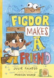 Figdor Makes a Friend cover. Figdor, a square-headed boy, is making the title out of paper, wood, and other craft materials. Blue background, yellow and red letters. By Julie Falatko. Illustrations by Marissa Valdez.